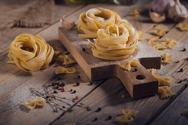 Raw homemade pasta with flour and spices on the rustic backgroun - Fotografie, Obrázek