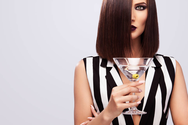 Fashion studio photo of beautiful young lady with martini glass. Perfect face makeup. Beauty makeup. - Foto, immagini