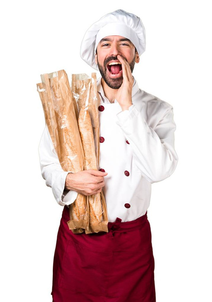 Young baker holding some bread and shouting - Fotoğraf, Görsel