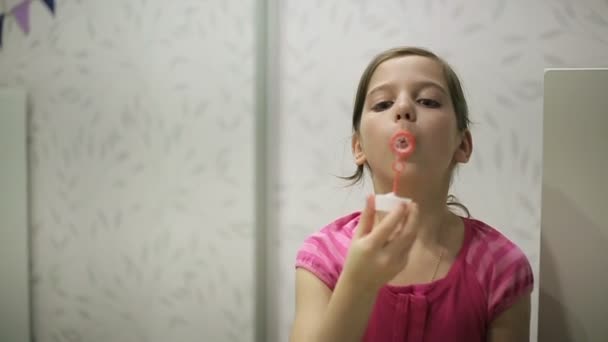 Little girl blows soap bubbles slow motion - Felvétel, videó