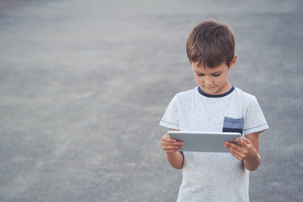 Boy with tablet computer. School, education, technology, leisure concept - Photo, Image
