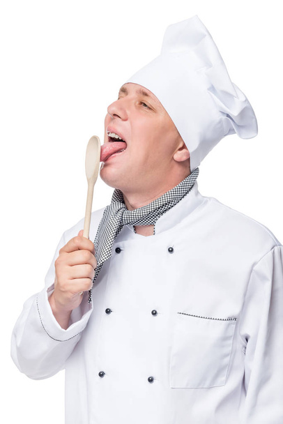 chef licks a wooden spoon, portrait isolated on white background - Photo, Image