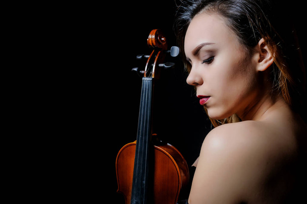 Beautiful young woman playing violin - Фото, зображення