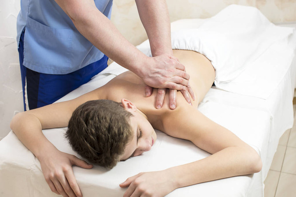 teenager on the procedure of medical medical sports body massage - Photo, image