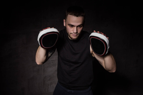Boxer trainer with training mitts on hands - Φωτογραφία, εικόνα