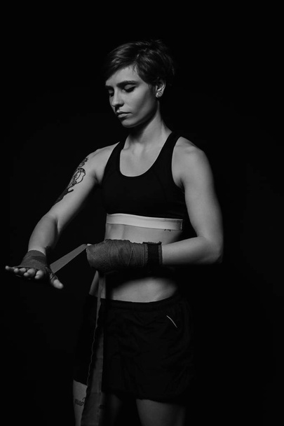 Woman wrapping hands with boxing wraps - Foto, imagen