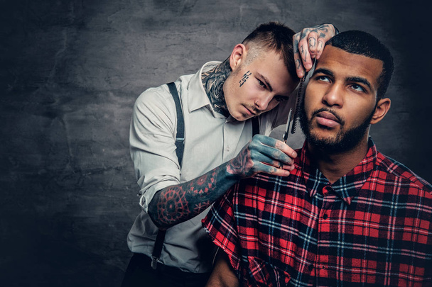 Tattooed barber cuts the beard - Photo, Image