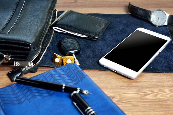 Business accessories on desktop: bag, watch, pen, perfume, cufflink and phone. Success in business. - Фото, изображение
