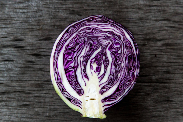 Close-up of red cabbage at a wooden background - Фото, изображение