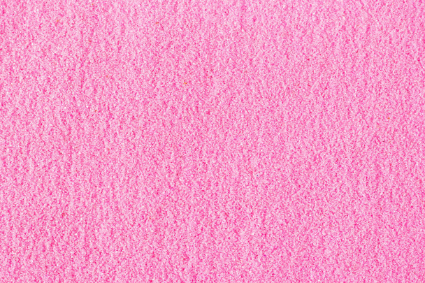 Beautiful pink decorative sand scattered on the table. - Photo, Image