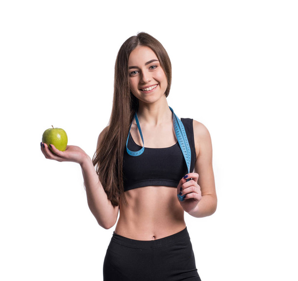Slim and healthy young woman holding measure tape and apple isolated on white background. Weight loss and diet concept. - Fotoğraf, Görsel