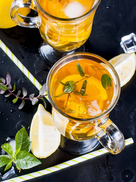 Cold tea with lemon, mint and ice - Zdjęcie, obraz