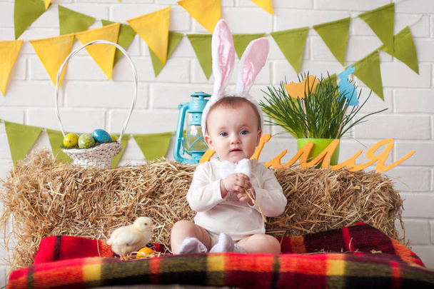 Cute little baby wearing bunny ears on Easter day - Фото, изображение