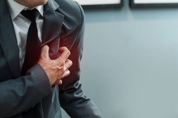 Close up Businessman in grey suit has heart attack. Exhausted, I - 写真・画像