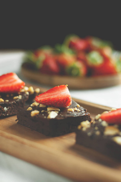 Homemade chocolate brownies with strawberries topping on black b - Fotografie, Obrázek