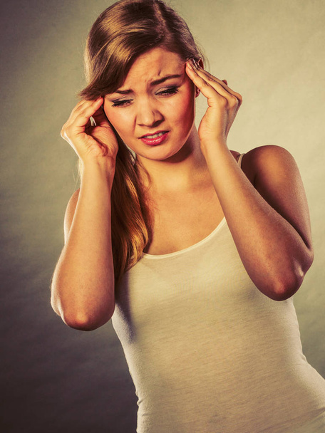 Woman suffering from headache migraine pain. - Фото, изображение