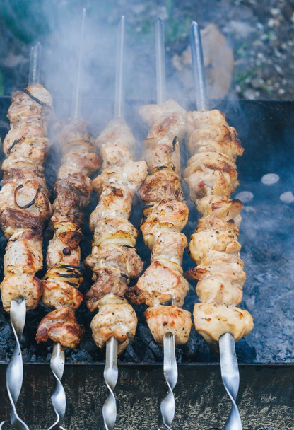 Cooking meat on the fire top view, shish kebab on skewers, smoke - Photo, Image