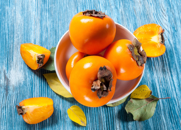 Persimmons on table - Foto, imagen