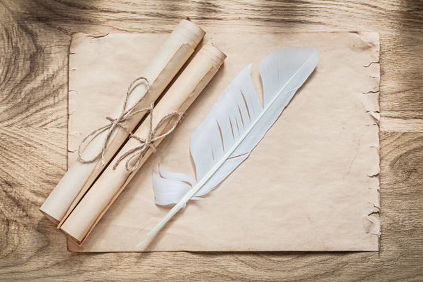 Medieval parchment paper scrolls feather on wooden board - Фото, зображення