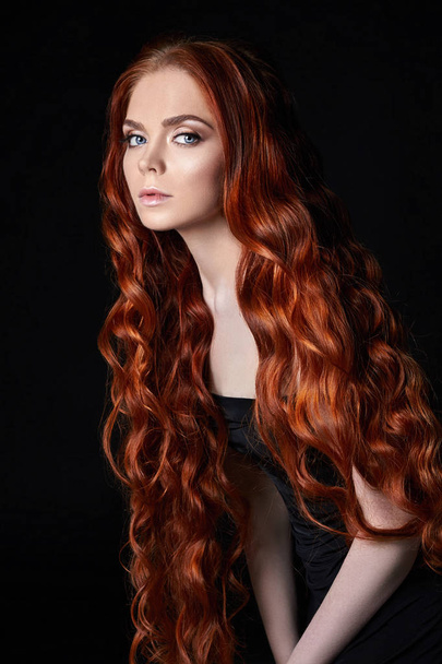 Sexy beautiful redhead girl with long hair. Perfect woman portrait on black background. Gorgeous hair and deep eyes. Natural beauty, clean skin, facial care and hair. Strong and thick hair. - Foto, Imagem