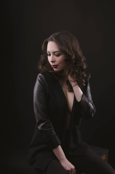 Sexy brunette woman in leather jacket at studio - Fotoğraf, Görsel
