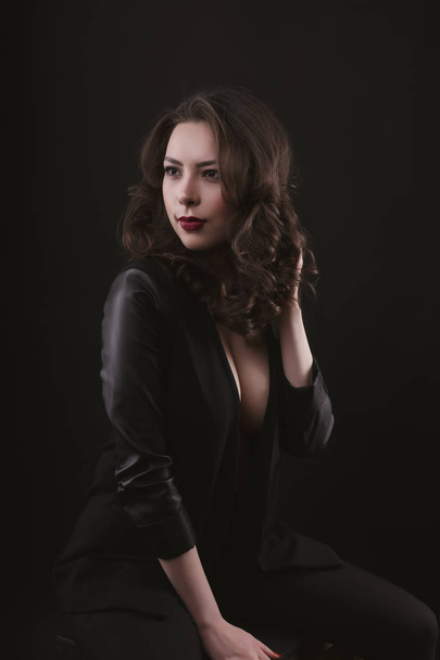 Attractive  brunette woman in leather jacket at studio - Valokuva, kuva