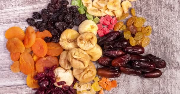 Dried fruits on wooden background - Footage, Video