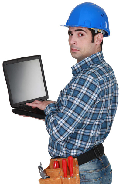 Craftsman typing on his laptop - Foto, imagen