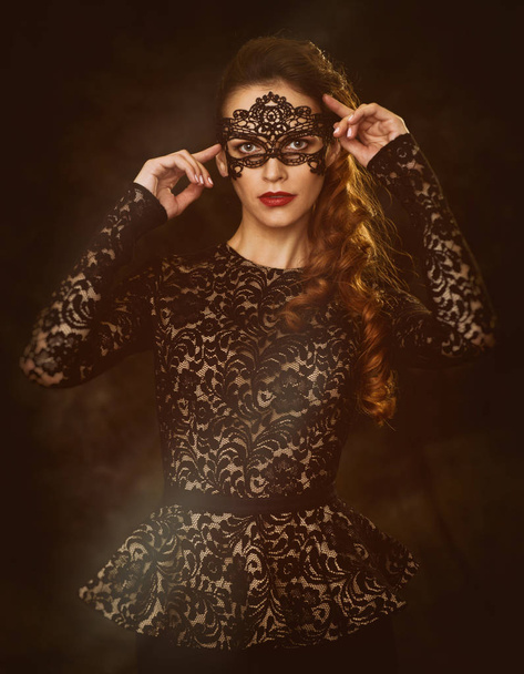 beautiful woman wearing a masquerade mask - Valokuva, kuva