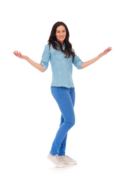 full body picture of a young casual woman welcoming you  - Photo, Image