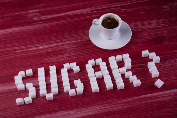 Sugar cubes word with espresso - Foto, Imagen