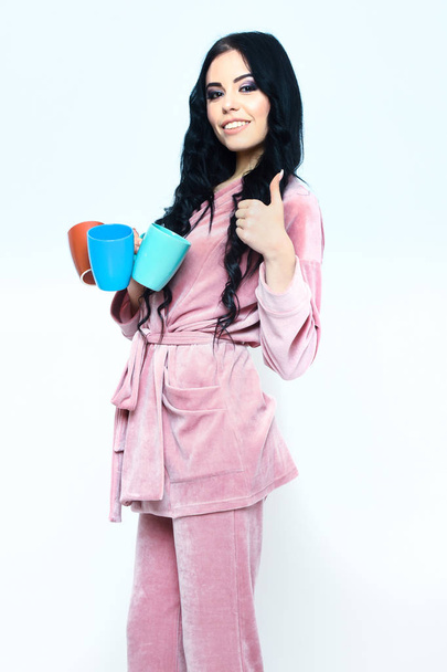 smiling girl in pink velour pajama home suit with cup - Foto, Imagen