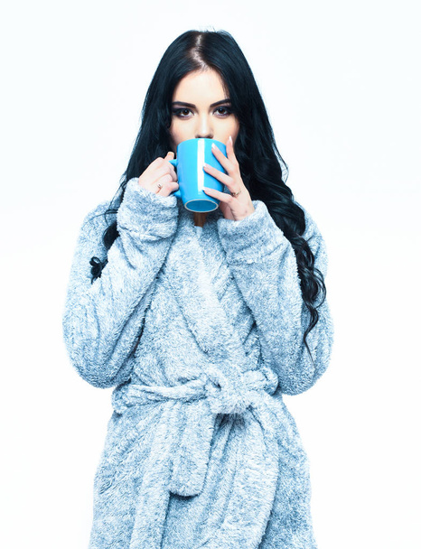 sexy girl posing in blue velour bathrobe with cup - Photo, Image