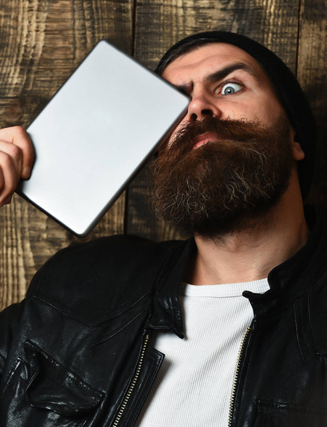 Bearded brutal caucasian hipster holding tablet - Foto, Imagen