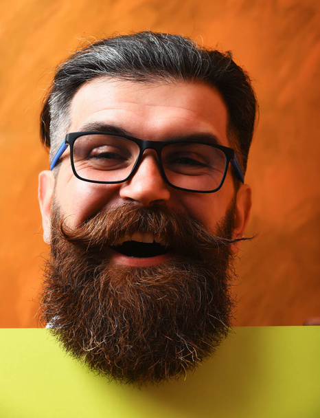 bearded man with happy face in glasses on orange background - Fotoğraf, Görsel