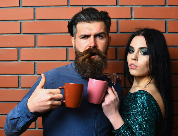 bearded man and pretty sexy woman with cigar, tea cups - Φωτογραφία, εικόνα