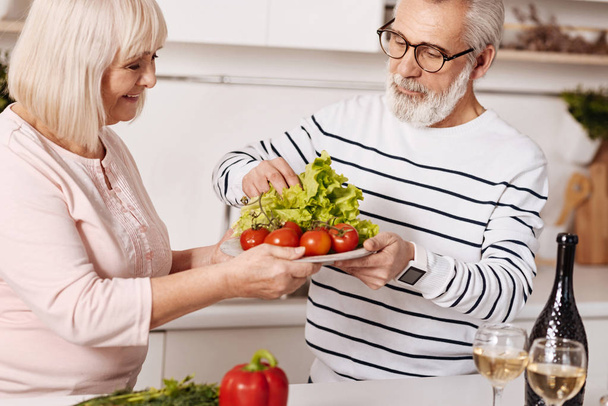 Helpful aged couple preparing family dinner together  - Foto, immagini