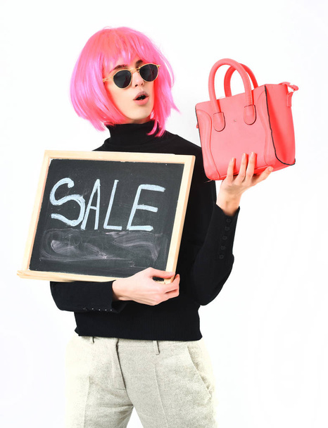 girl in wig holding bag and board with sale inscription - Foto, immagini