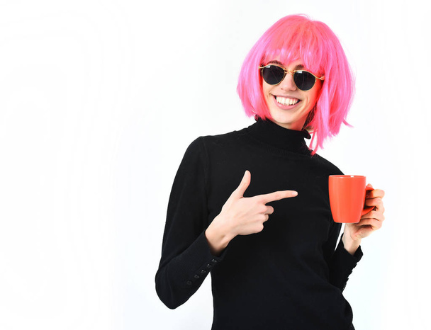 fashionable sexy girl in pink wig holding orange cup - Foto, Bild