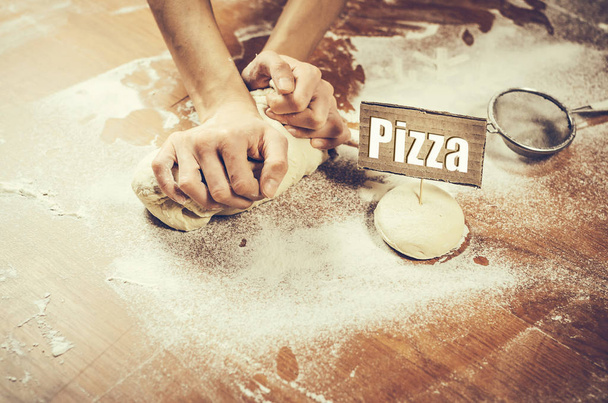 Female hands pressing dough  - Foto, Bild