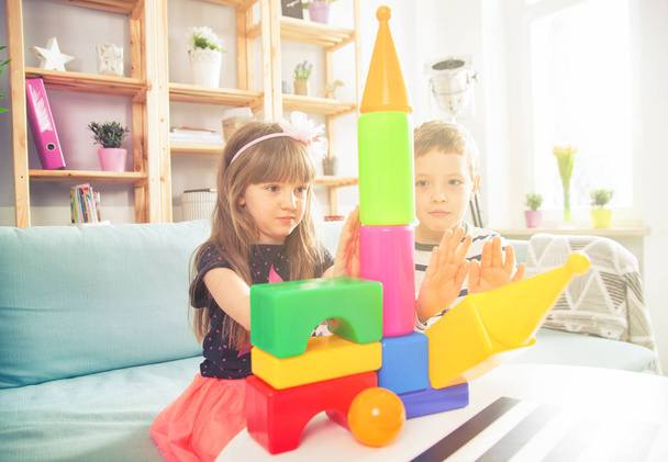 Irmãos brincando com blocos coloridos em casa, família feliz
 - Foto, Imagem