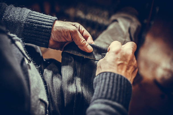 Tailor sewing some fabric - Φωτογραφία, εικόνα