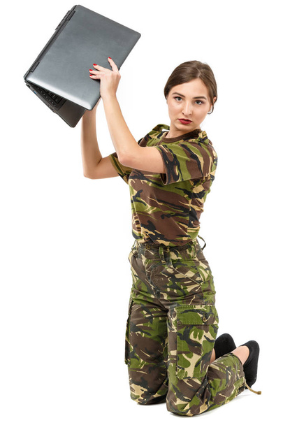 young woman soldier in camouflage outfit with a laptop - Photo, Image
