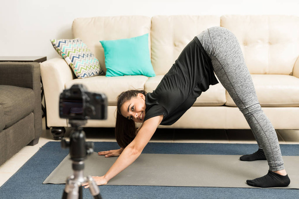 Blogger demonstrating yoga pose on video - Fotó, kép