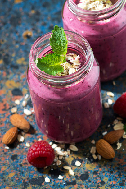 berry smoothie in a bottle on a dark background, top view - Foto, imagen