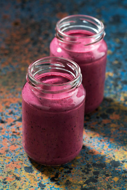 berry smoothie in bottles, vertical - Fotó, kép