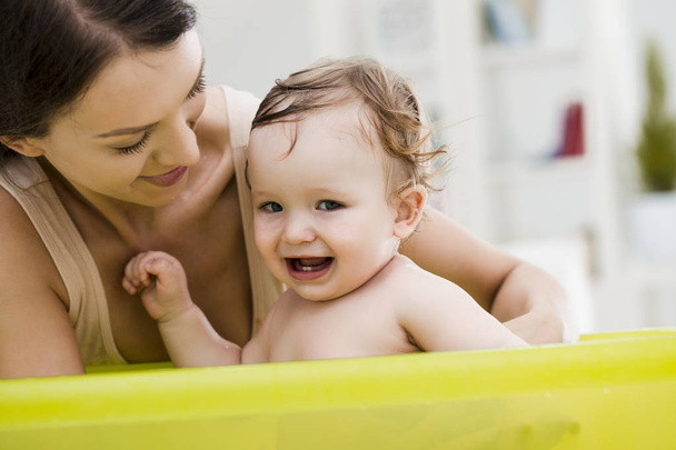 Mother Bathing her Baby - Photo, Image