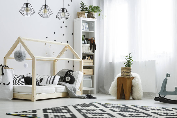 Bedroom with wooden house bed - Valokuva, kuva