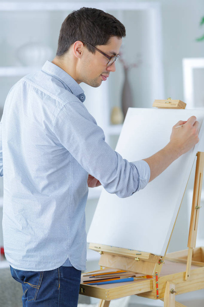 portrait of a young male artist at work - 写真・画像