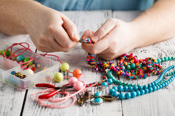 Making of handmade jewellery, front view of male hands - 写真・画像